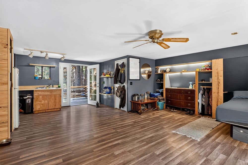 Open living area with built-in shelving on a Shingletown acreage listing